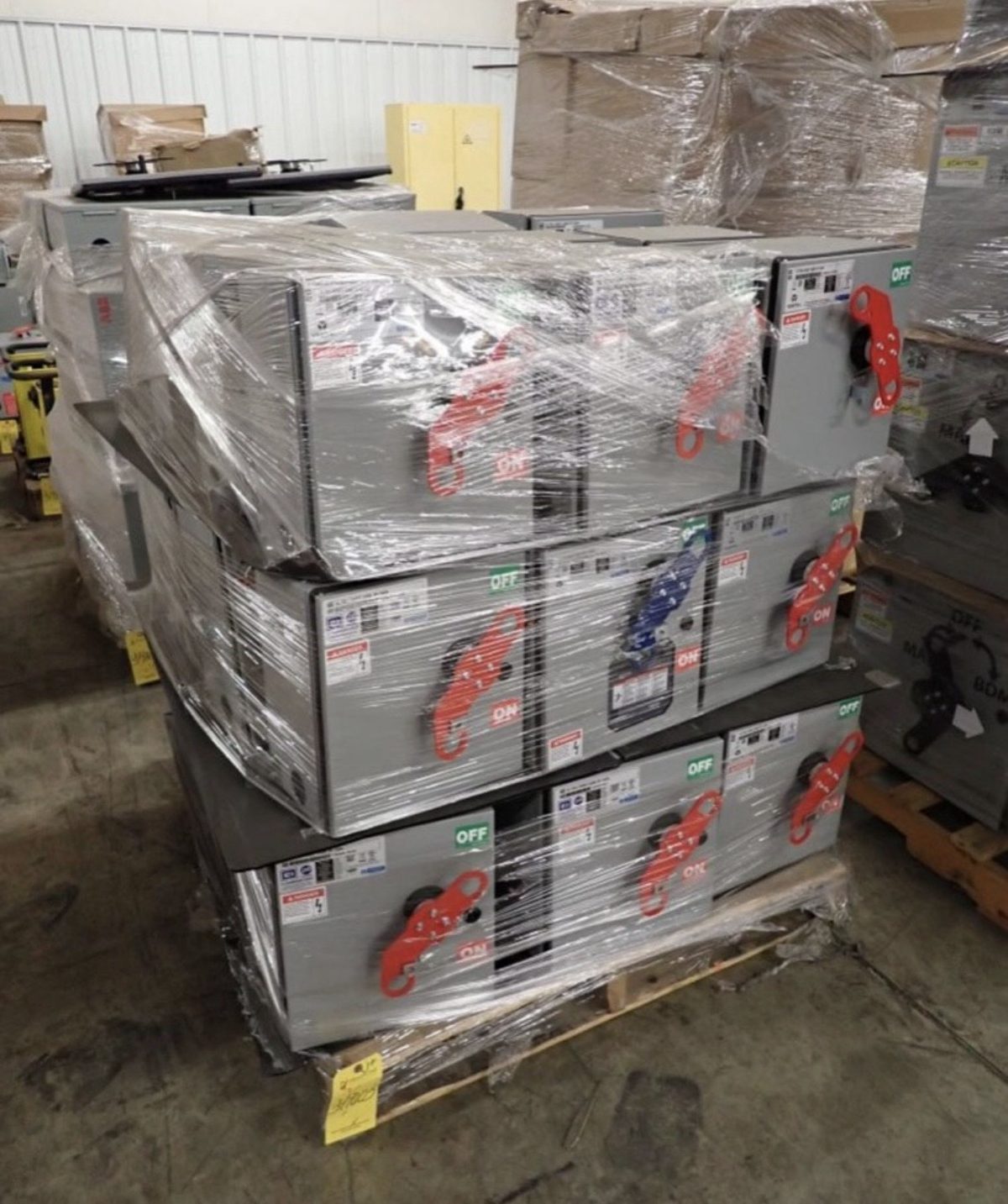 Pallets of bus plugs shrink-wrapped and ready for freight after a surplus electrical equipment purchase