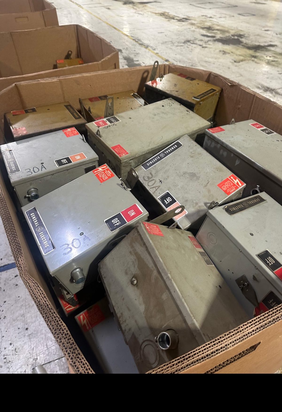 Pallet box of General Electric 30 amp fusible bus plugs purchased from an industrial facility