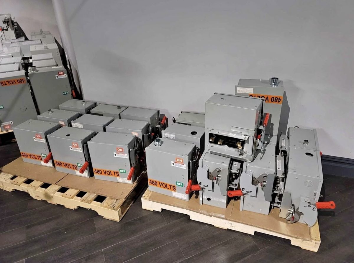Rows of 480 volt bus plugs lined up on pallets after a plant decommissioning purchase