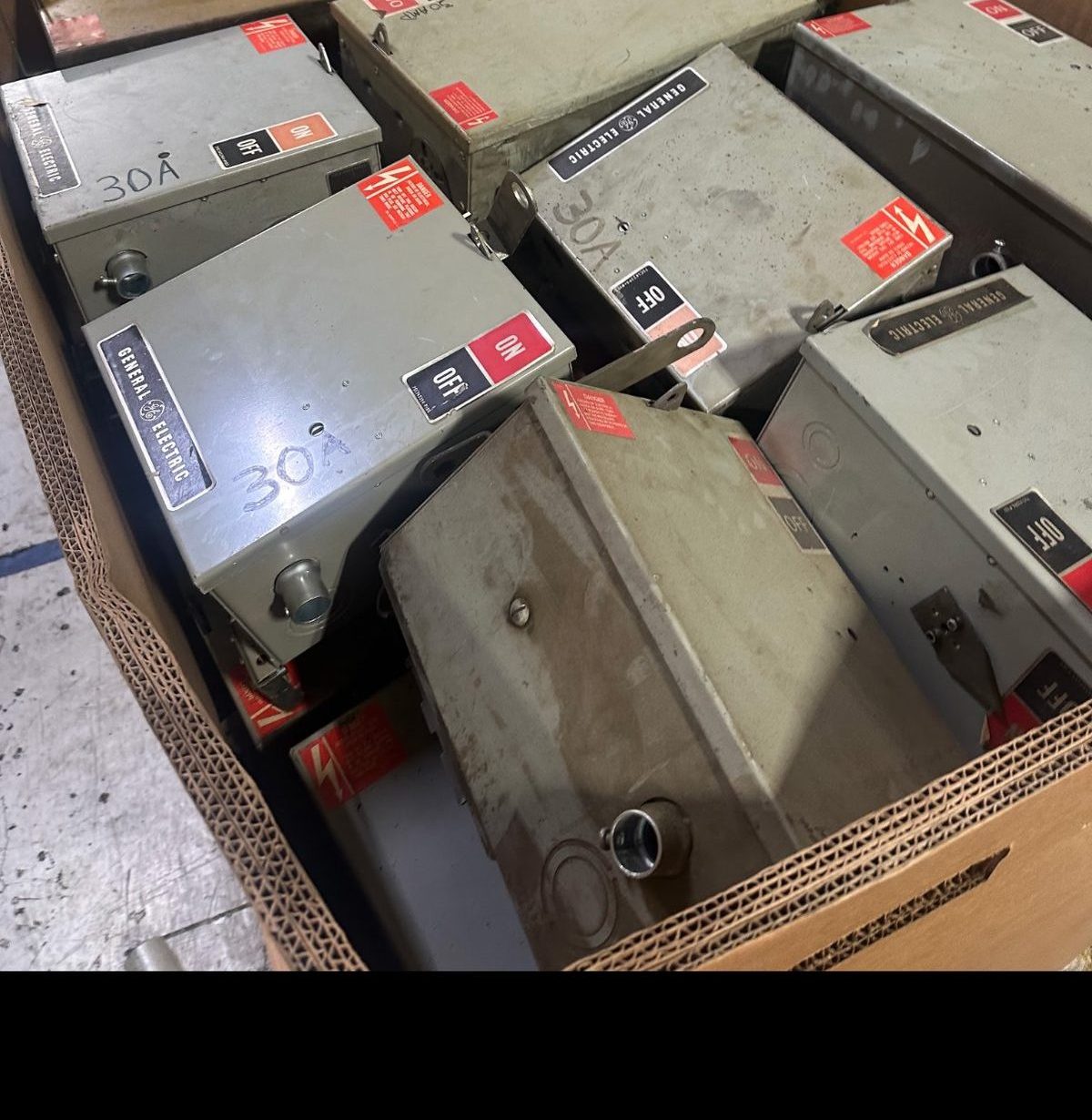 Used fusible bus plugs boxed on a pallet for shipment after a surplus buyout